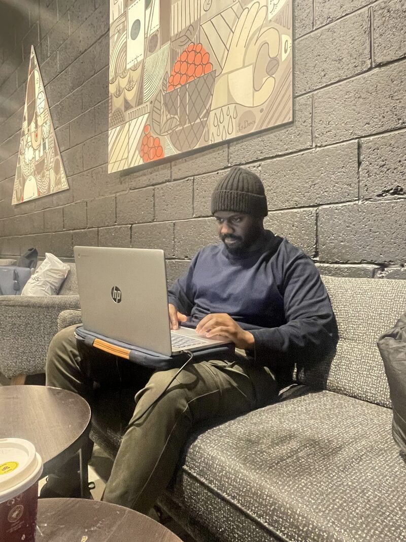 Kenny working at a laptop planning a client programme